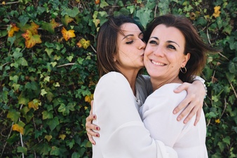 woman-kissing-woman-garden_23-2147784526